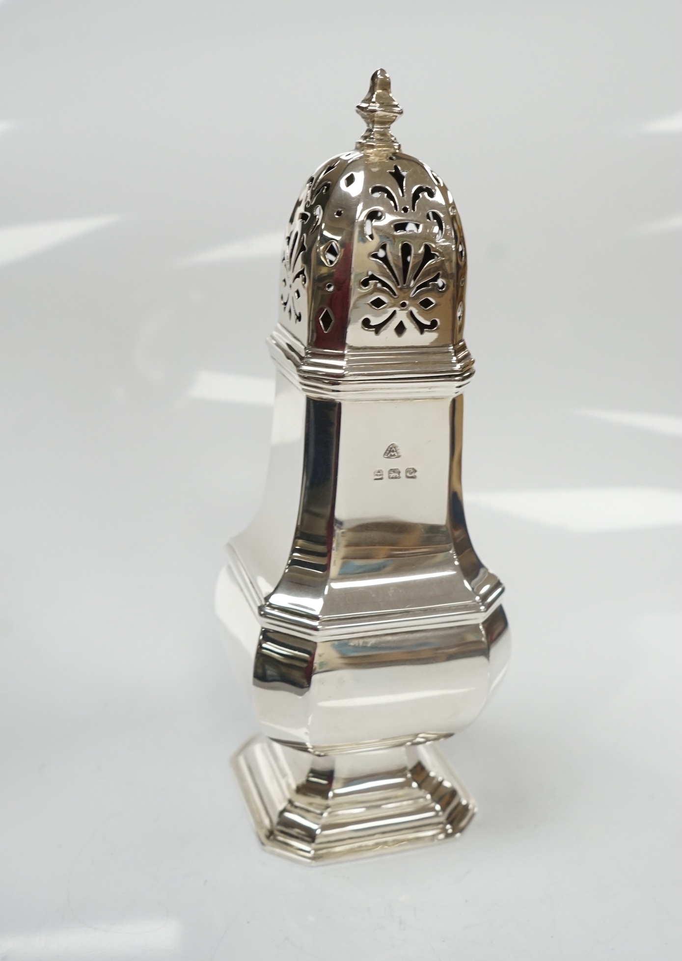 A George V silver octagonal baluster sugar castor, by Adie Bros, height 18.3cm, 5.3oz. Condition - poor